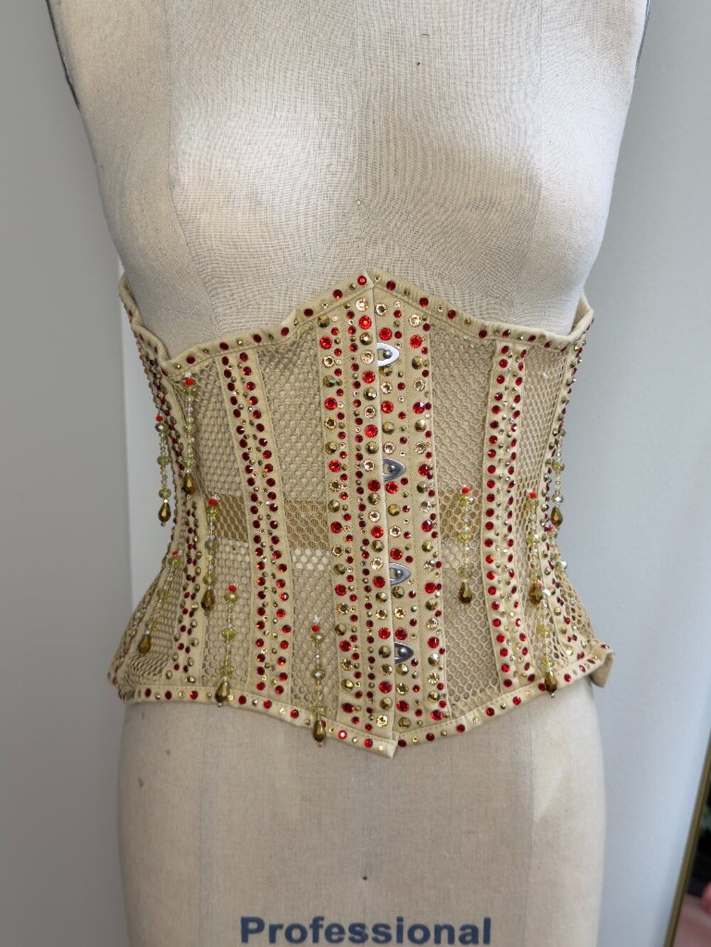 Burlesque corset with Swarovski red and gold rhinestones. Size 24/beige